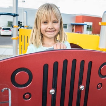 Girl smiles over a sensory panel