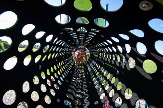 girl crawling in a tunnel made with textured rubberized belting