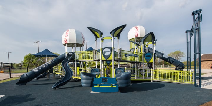 Two story inclusive playground with custom baseball tower roofs at the Ankeny Miracle Park. 