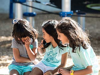 Group of girls taking a break and enjoying deep conversation on the playground