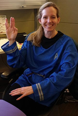Landscape Structures Lora Geiger holds her hand up with a Vulcan salute while wearing a Star Trek Halloween costume.