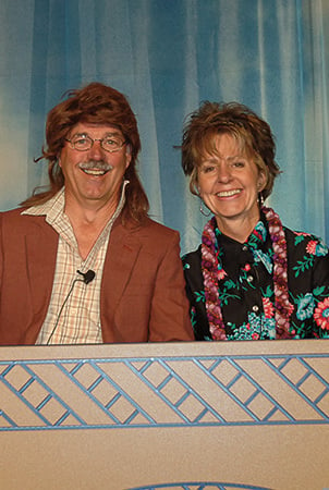 Picture of Barb and Steve King -- Steve is wearing a wig and both appear to be laughing. 