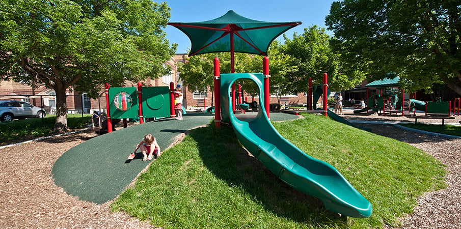 Front view of a Slidewinder2 slide at a PlayBooster playground.
