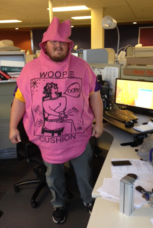Landscape Structures Trevor Ryks poses for the camera at his cubical wearing a woopy cushion Halloween costume.